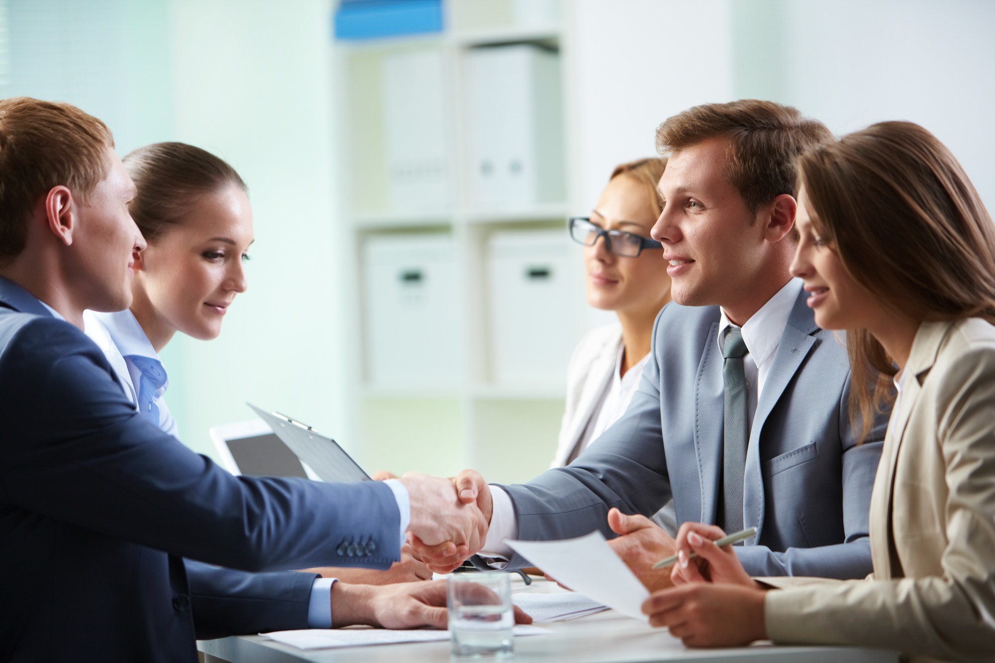Confident businessmen handshaking at meeting